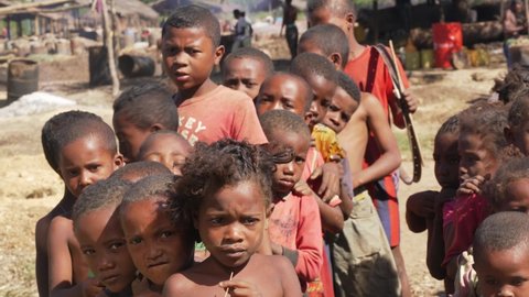 Andranovory, Madagascar - April 30, 2019: Group of unknown Malagasy kids standing together on sunny day in torn clothes - people in Madagascar are poor but cheerful, especially children