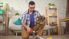 man cleans shoes from dirt with a special brush