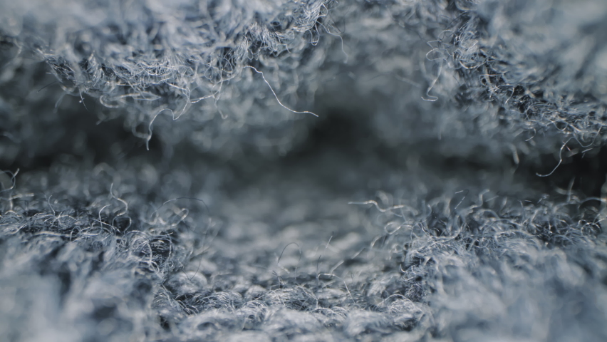 Macro shot of woolen fabric. Slider dolly extreme close-up of clothing material blue fabric texture. Woollens, woolens, wool fibers. Warm winter clothing. Shot with laowa 24mm probe lens | Shutterstock HD Video #1063795774