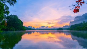 Time lapse 4K of Nature video footage Amazing Light of nature Landscape sunrise or sunset over lake and mountain peak with reflection in the water around the pond at morning time Amazing scenery natur