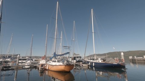 Knysna , Western Cape , South Africa - 11 14 2020: Cruising out of marina full of sailboats on blue sky sunny Knysna day
