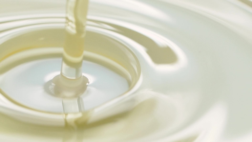 Slow motion closeup pouring olive, sunflower oil liquid, healthy food background