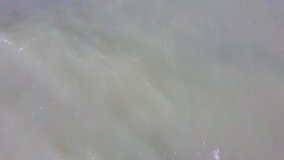 Aerial Dron Shot of the Baltic Sea Costline With Waves View From Above. Sea Waves Over a Sandy Beach. Top View of Sea Waves Foaming and Splashing, Big Waves From Above. 4K Video