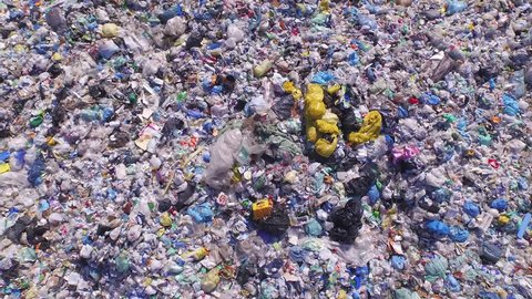AERIAL: Endless pile of plastic bottles, bags and other waste