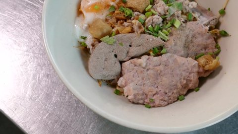 Close-up Footage of Thai Styled Tom Yum Noodles Contained With Egg Noodles, Minced Pork Cake, Pork Liver, One of The Favourite Street Food in Thailand