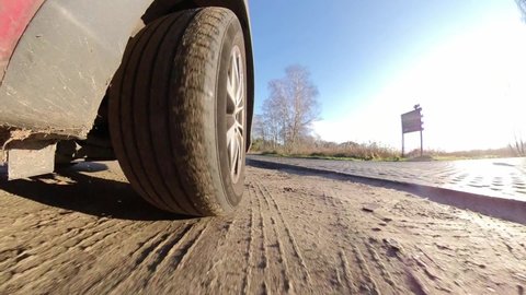 Car Front Tyre and Suspension System When Driving on Openwork Plates Road POV