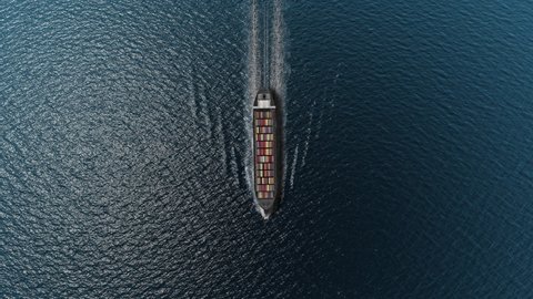 Cargo ship with containers in the open blue sea- Top down view 
, Freight Shipping export and import concept, container ship carries cargo across the ocean. 