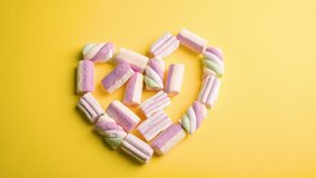 Heart from marshmallows sweets on a yellow background. STOP MUSH. Sweet gift, Symbol of Valentine's Day and all lovers. Color pattern for 2021. High quality FullHD footage - Powered by Shutterstock - Get 15% off with code: PIKWIZARD15