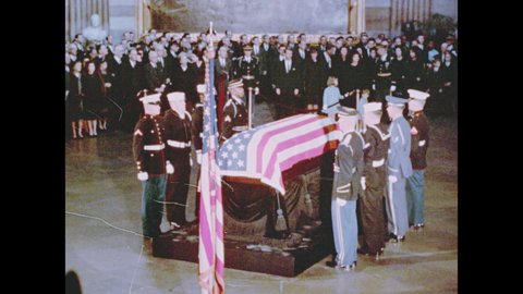 1960s Washington DC: Jackie, Caroline, Bobby Kennedy in crowd near flag-draped coffin, soldier leads JFK Jr away