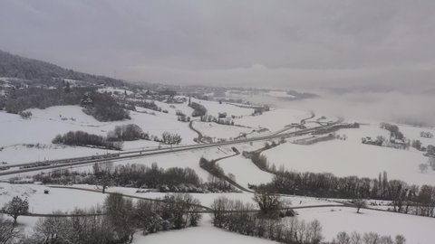France, Andilly, Haute-Savoie A41 highway surrounded by snow, drone aerial view during winter