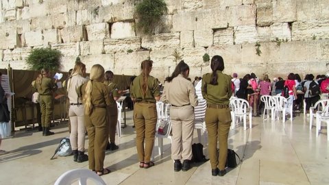 JERUSALEM, ISRAEL – MAY 15, 2018: Jew and tourist women praying at the Western Wall, in the separated are for females, in the holiest place for Judaism