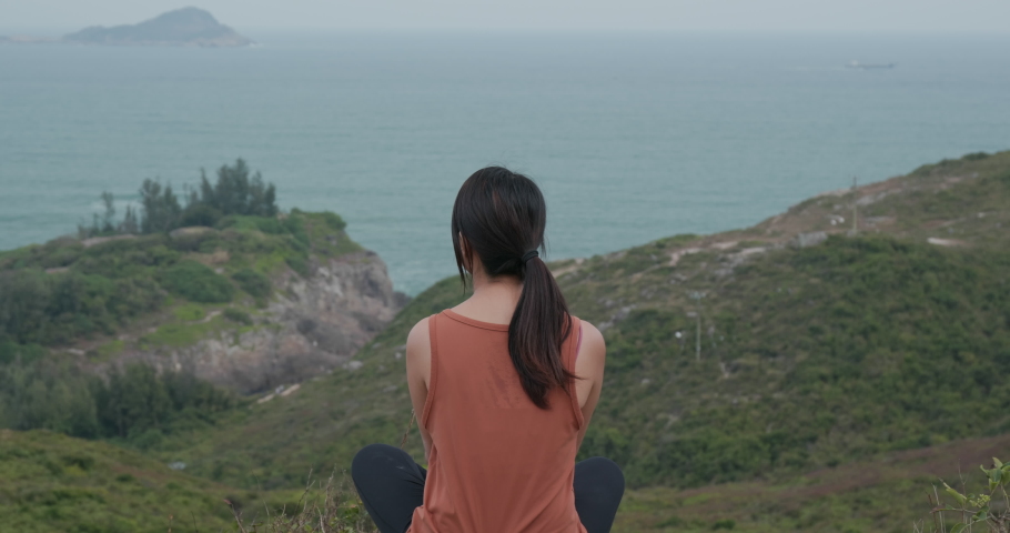 Woman sit at the top of the mountain