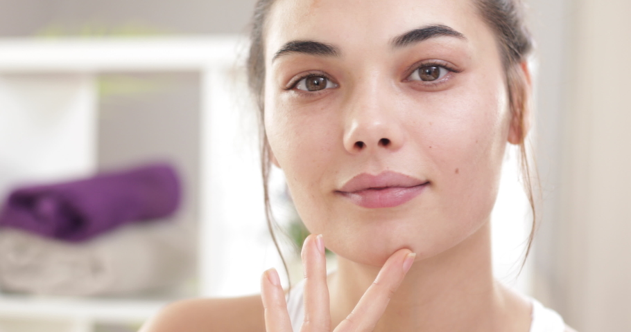Young woman making cosmetic skin care | Shutterstock HD Video #1063852576