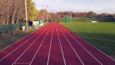 Aerial footage of running track in a sport stadium. first person view of a runner in a competition. Victory at the finishing line.