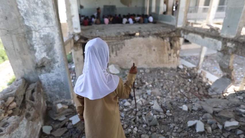 Taiz _Yemen_ 07 Oct 2020 : A sad Yemeni child looks at the camera in her school hall, destroyed by the war in the city of Taiz, Yemen