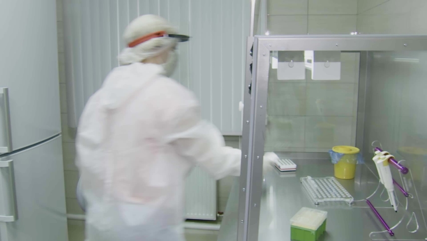A laboratory assistant performs a test for COVID-19 by polymerase chain reaction. Royalty-Free Stock Footage #1063857169