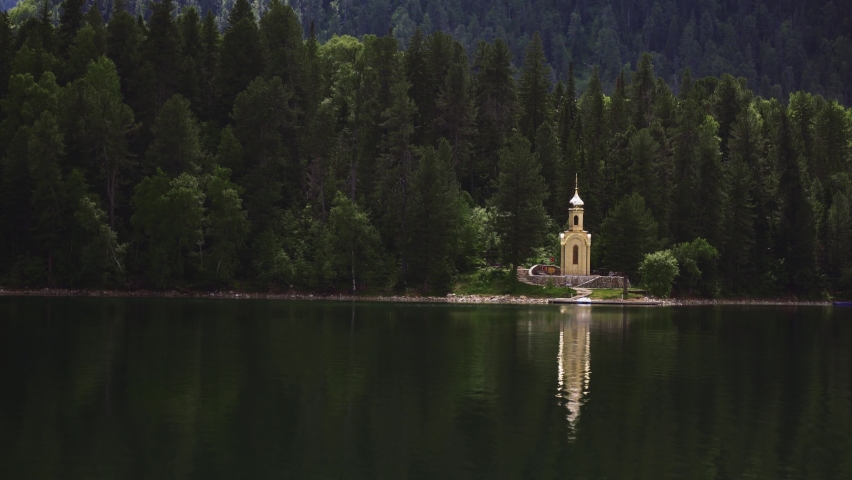 chapel by the lake in the coniferous forest