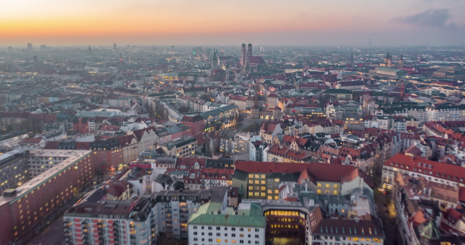 Beautiful Munich, Germany Establishing Shot Hyperlapse above City Center with Frauenkirche Cathedral and Marienplatz, Day to Night Time Lapse with Sunset and Big City traffic Hyper Lapse Royalty-Free Stock Footage #1063861318