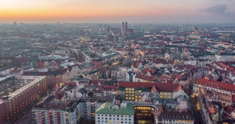 Beautiful Munich, Germany Establishing Shot Hyperlapse above City Center with Frauenkirche Cathedral and Marienplatz, Day to Night Time Lapse with Sunset and Big City traffic Hyper Lapse