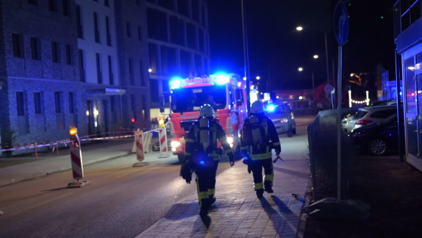 SLOW MOTION: German Fireman walking towards Fire Truck in Frankfurt am Main, Germany at Night  Royalty-Free Stock Footage #1063861519