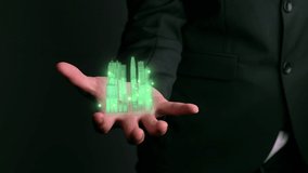 Businessman holds 3D city model showing augmented reality technology . Futuristic urban hologram screen in concept of virtual internet of things and global network connection . - Powered by Shutterstock - Get 15% off with code: PIKWIZARD15