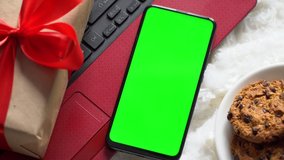 Top view. Chroma key smartphone with green screen. Christmas gift