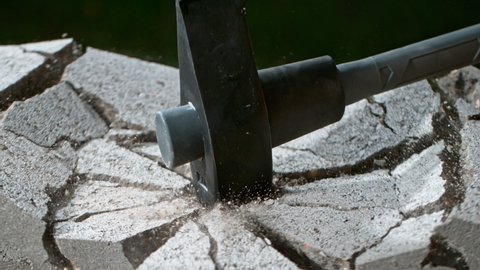 Super Slow Motion Shot of Smashing Concrete Brick with Sledgehammer at 1000fps.