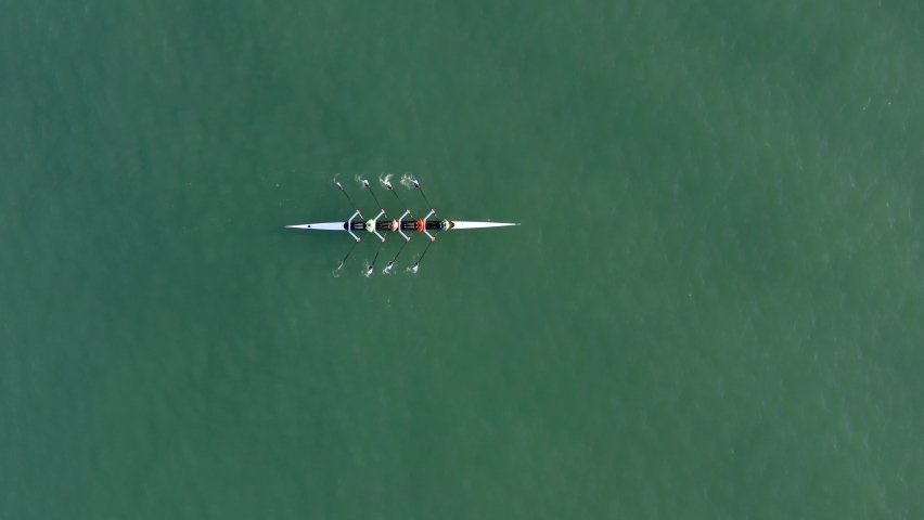 Sport Canoe with a team of four people rowing on tranquil water, Aerial view. Royalty-Free Stock Footage #1063880191