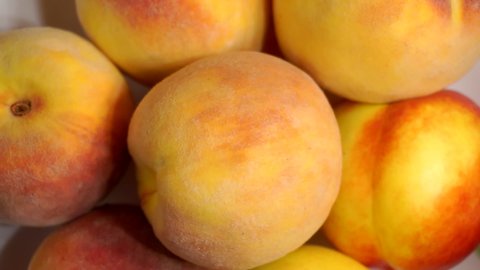 fruit close-up.ripe juicy bright peaches lying on a plate.shallow depth of field.view from above