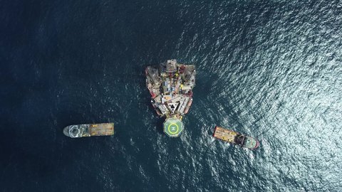 Offshore jack up rig and tow vessels during the rig move operation at the offshore location via drone shot
