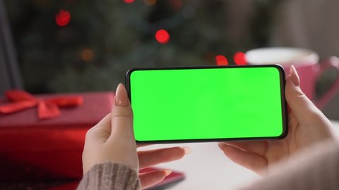 Close up shot of female , holding a smartphone with chroma key mock up green screen - technology, connections, communications concept 4k video template