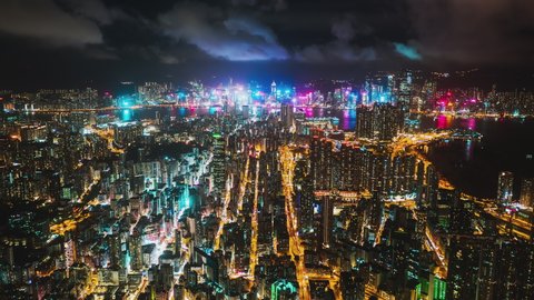 Hyperlapse time-lapse of Hong Kong cityscape, traffic transportation at night, Victoria Harbour drone aerial view. Asia travel, Asian tourism, city life, or business finance and economy concept