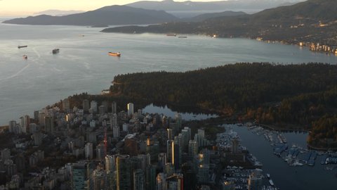 Downtown Vancouver Skyline And Stanley Park During Sunset - aerial view, Tilt Up
