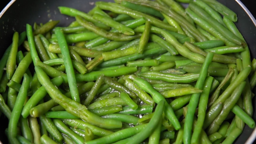 Green beans ready for cooking in frying pan. Bio green beans. cooking healthy home-made food Royalty-Free Stock Footage #1063918933