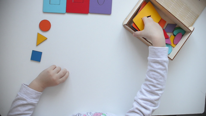 Learning colors and shapes. Children's wooden toy. The child collects a sorter. Educational logic toys for kid's. Kindergarten educational toys, Cognitive skills, Learn Through Play tools concept. | Shutterstock HD Video #1063926706