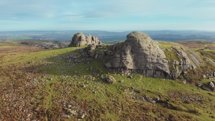 Aerial drone footage of natural granite rock formations of Haytor and green countryside, Dartmoor National Park Royalty-Free Stock Footage #1063926874
