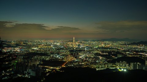 Time lapse 4K Seoul city skyline and Seoul tower modern building and architecture, Beautiful clouds flow through at nigth  in Seoul, South Korea.