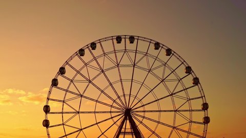 accelerated shooting. Ferris wheel against a sunset sky. entertainment for tourists. walks through the resort town. 