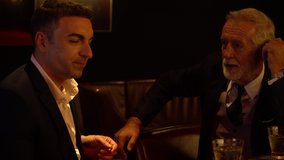 Cheers . senior executive business man and customer toasting with whiskey and handshake on bar counter at nightclub or pub . old man drinking alcohol in meeting after work to deal business Agreement - Powered by Shutterstock - Get 15% off with code: PIKWIZARD15