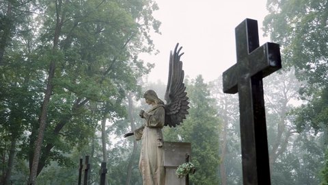 VILNIUS, LITHUANIA - 2020: An old Angel statue at the Bernardine XIX century cemetery on a foggy day. Filmed in slow motion. 