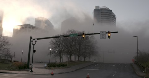 
ROSSLYN, VIRGINIA, USA - December 13, 2020: City under dust clouds after building demolition, Implosion of Rosslyn Holiday Inn Hotel Tower