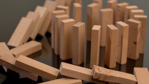A row of a wooden domino falling down.