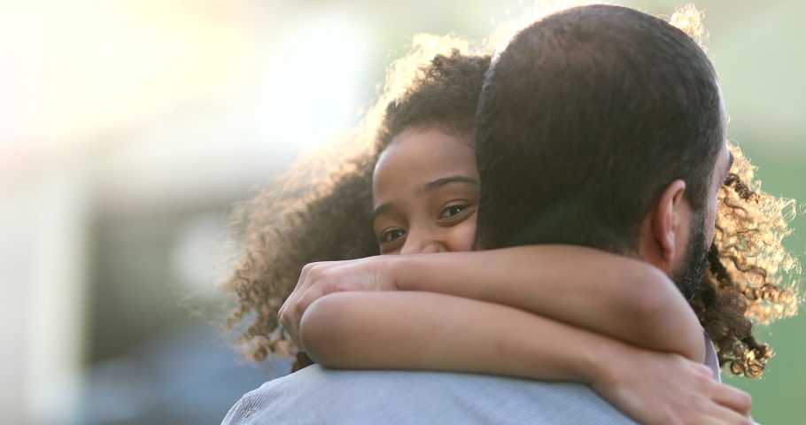 Daughter hugging father outside. Mixed race ethnicity little girl hugs dad Royalty-Free Stock Footage #1063941139