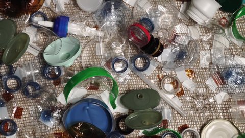 Single use plastic garbage from one household. Bring awareness to over pollution of landfill by non recyclable plastic waste. Toxic non biodegradable garbage on the table. Environmental issues.