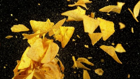 Super slow motion of flying tortilla chips hitting up in the air. Filmed on high speed cinema camera, 1000 fps.