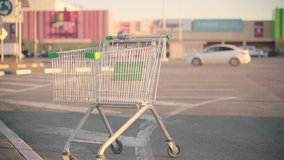 Grocery cart on parking in sunny weather. Empty abandoned shopping cart on street. - Powered by Shutterstock - Get 15% off with code: PIKWIZARD15