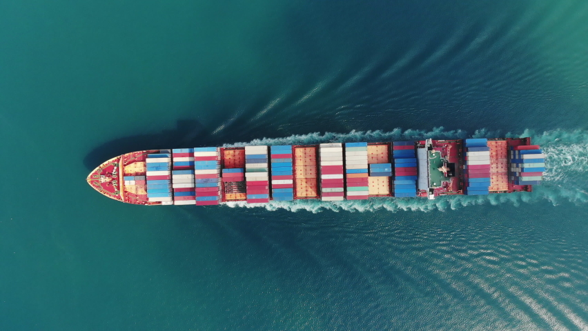 Aerial top view of smart cargo ship carrying container and running very fast for export cargo from container yard port to custom ,Contrail line in the ocean by large ship very fast.  | Shutterstock HD Video #1063952977