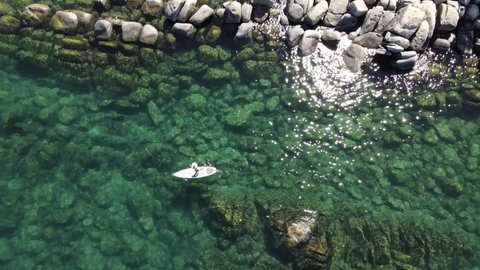 4K Aerial Flyover of Woman Paddle Boarding in Lake Tahoe Clear blue water