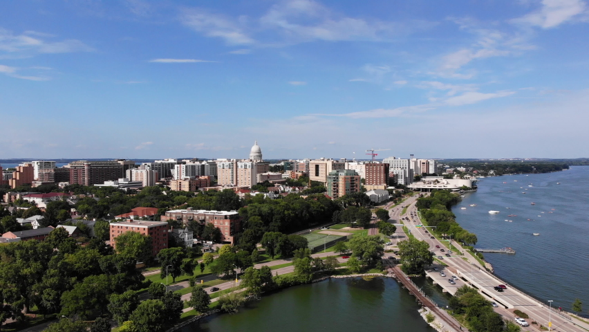 Drone Aerial View of Madison, Wisconsin USA. Cityscape, Downtown in Skyline and Traffic on Freeway by Monona Lake on Sunny Summer Day