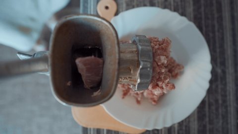 Cooking Minced Meat at Home. Hands In A Light Kitchen Make Minced Meat On A Handmade Old Meat Grinder. View From Above. Meat Cooking Concept.